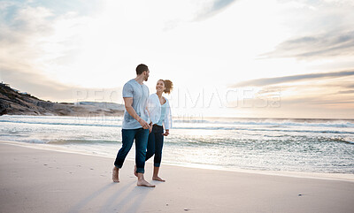 Buy stock photo Couple, holding hands and walking on beach at sunset for Portugal holiday, vacation and travel break by nature ocean mockup. Smile, bonding and love for man and woman on sea sand for romantic sunrise