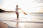 Swing, beach and father with girl child holding hands in nature for play, freedom or bond at sunset. Ocean, travel and parent with kid at sea for spinning fun, games and celebration adventure in Bali