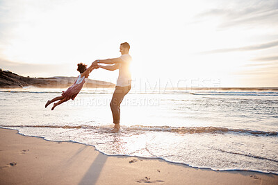 Buy stock photo Beach, swing and father with girl child holding hands in nature for play, freedom or bond at sunset. Ocean, travel and parent with kid at sea for spinning fun, games and celebration adventure in Bali