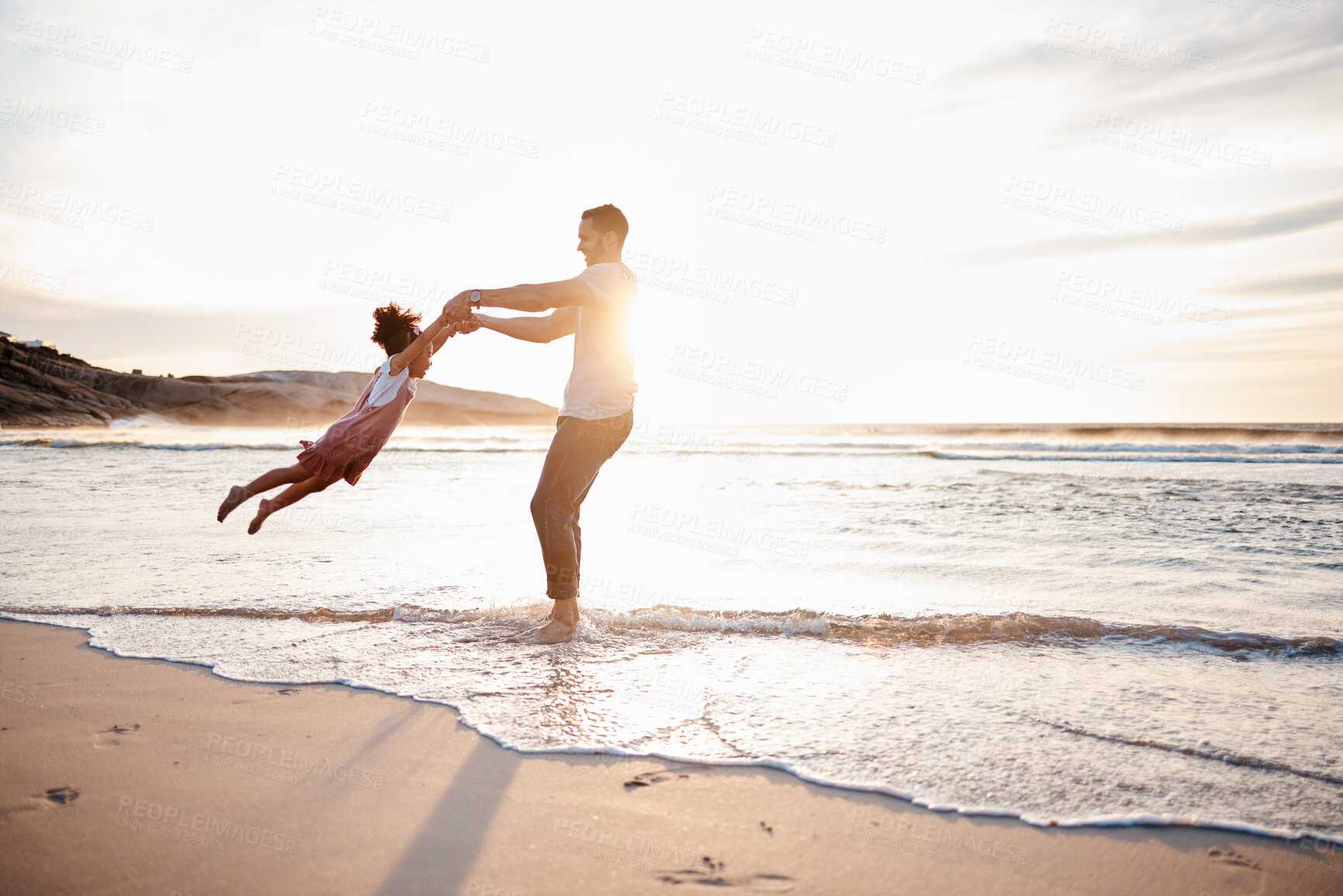 Buy stock photo Beach, swing and father with girl child holding hands in nature for play, freedom or bond at sunset. Ocean, travel and parent with kid at sea for spinning fun, games and celebration adventure in Bali