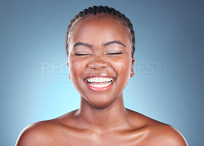 Buy stock photo Beauty, skincare and black woman with laughing, cosmetics and makeup in studio. Wellness, African female model and funny with blue background and skin glow with shine from dermatology and treatment
