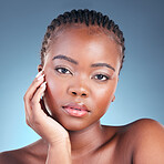 Beauty, black woman and portrait with skincare, cosmetics and  facial wellness in a studio. Blue background, makeup and dermatology with skin glow and shine from treatment with manicure and detox
