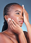 Beauty, black woman and thinking with skincare, cosmetics and  facial wellness in a studio. Blue background, makeup and dermatology with skin glow and shine from treatment with manicure and detox