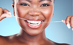 Happy woman, teeth and dental floss in cleaning, grooming or skincare against a blue studio background. Closeup of female person with big smile flossing in tooth whitening for oral, mouth or gum care