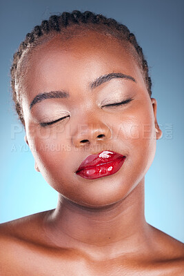 Buy stock photo Makeup, lip gloss and black woman with beauty, dermatology and shine on a blue studio background. Skincare, person or model with cosmetics, glow or facial treatment with aesthetic, wellness or health