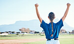 Woman, fist pump and winning, softball and athlete on outdoor pitch, celebration and success with sports. Back view, baseball player and yes, fitness and achievement, cheers and competition winner