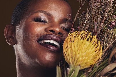 Buy stock photo Skincare, beauty and protea with the face of a black woman in studio on brown background for natural treatment. Smile, plant or cosmetics and a young model for sustainability or wellness with flowers