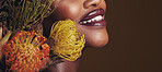 Beauty, makeup and plants with lips of black woman in studio for natural, spa and mockup space. Cosmetics, flowers and closeup with model on brown background for sustainability, glow and banner