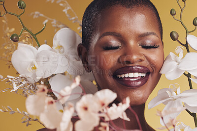 Buy stock photo Black woman, flowers and beauty with smile, makeup and natural cosmetics isolated on studio background. African model, orchid and nature, sustainable skincare with eyes closed, facial and glow