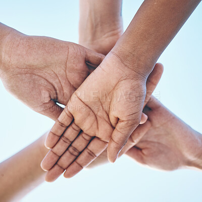 Buy stock photo Blue sky, hands stack and together for team building motivation, group cooperation or community goals support. Closeup below view, synergy commitment and people collaboration, teamwork and solidarity