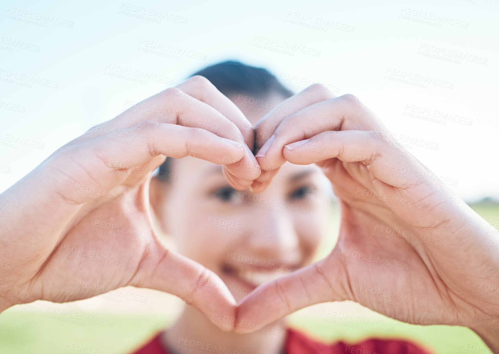 Buy stock photo Heart shape, closeup and hands of woman with a care, sweet and cute gesture outdoor on a field. Happy, smile and zoom of a young female person with a love sign or emoji in a outside park or garden.