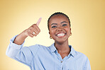 Black woman, portrait and thumbs up, feedback and support with smile isolated on yellow background. Happy, agreement and hand gesture with positive review, yes and like emoji with success in a studio
