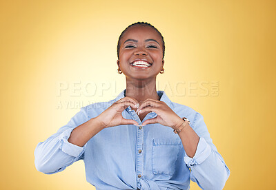 Buy stock photo Portrait, heart hands and black woman, smile and studio isolated on yellow background. Face, love sign and happy African person in kindness, care and empathy, support and trust, romance or solidarity