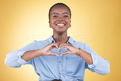 Buy stock photo Happy black woman, portrait and heart hands for support, love or care against a yellow studio background. Face of African female person smile with loving emoji, shape or symbol icon on valentines day
