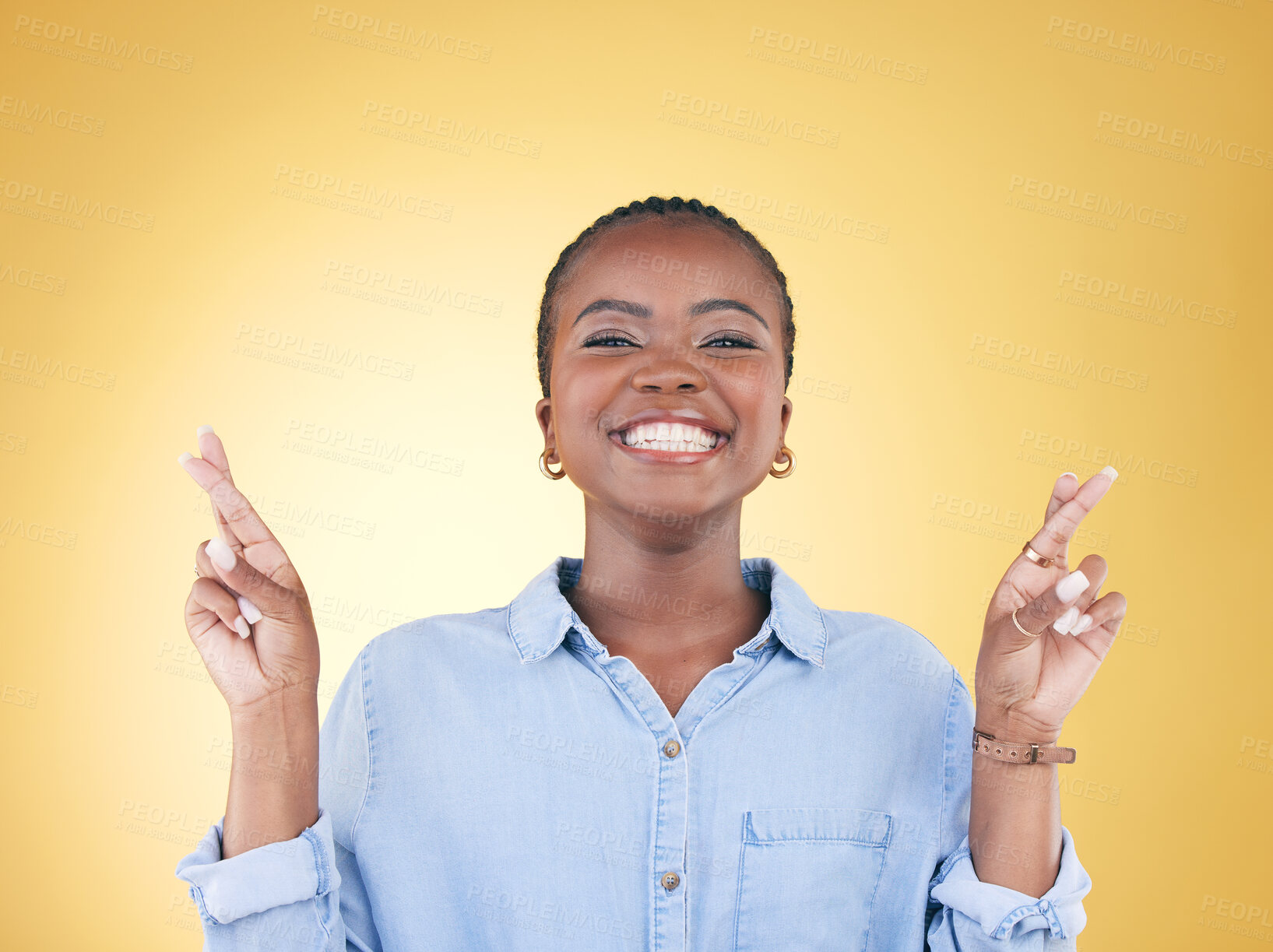 Buy stock photo Wish sign, fingers crossed and portrait of black woman in studio smile for hope, winning and success. Emoji, excited  and face of African person on yellow background with hand gesture for miracle