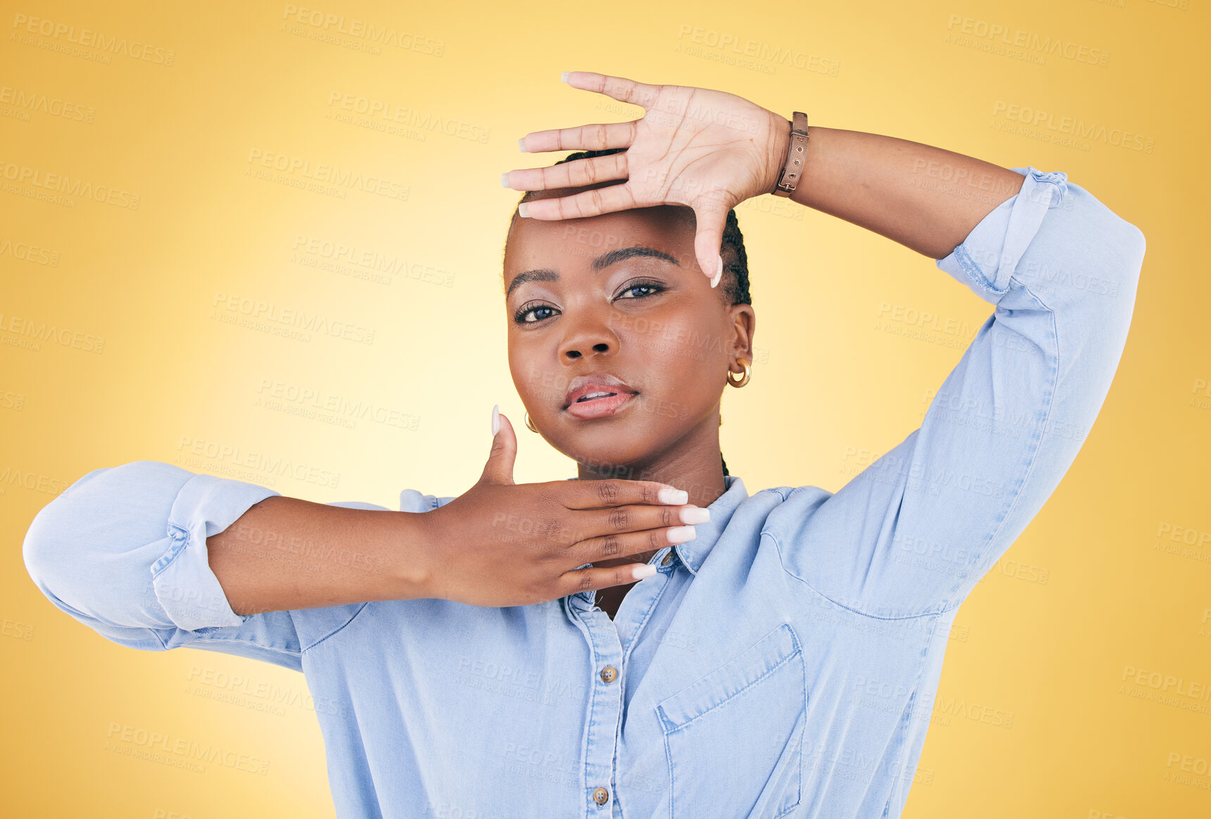 Buy stock photo Hands, frame and portrait of African woman in studio for confidence, creativity and beauty. Photography, perspective and face of serious person on yellow background with cosmetics, makeup and glamour