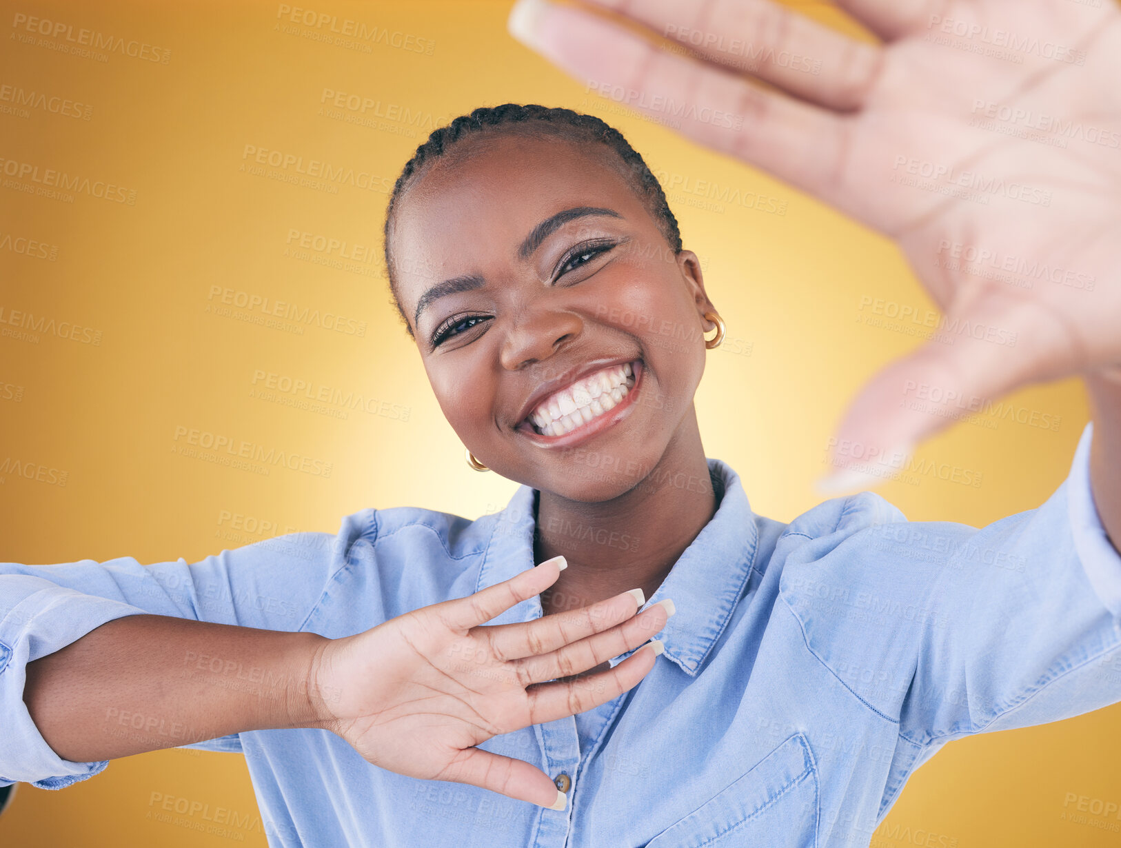 Buy stock photo Hands, frame and portrait of black woman in studio smile for confidence, creativity or beauty. Photography, perspective and face of African person on yellow background in cosmetics, makeup or glamour