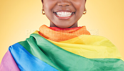 Buy stock photo Woman, mouth closeup and rainbow flag in studio for smile, teeth or happy for inclusion by yellow background. Lesbian girl, cloth or fabric for lgbtq equality, gay pride or excited for sign or vote