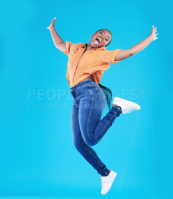 Buy stock photo Jump, black woman and excited portrait with motivation in studio from celebration smile. Happy, energy and African female person with promotion and blue background with leap from deal announcement