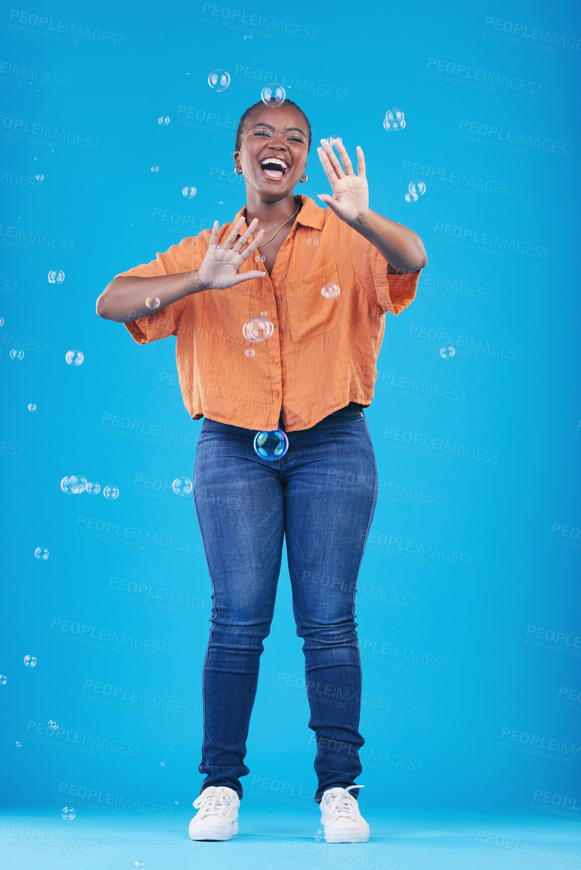 Buy stock photo Excited, happy and black woman on blue background with bubbles for happiness, joy and have fun. Playful, smile and isolated African person in studio with soap bubble for cheerful, magic and aesthetic