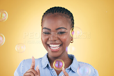 Buy stock photo Excited, pop and black woman on yellow background with bubbles for happiness, joy and fun. Playful, smile and isolated happy African person in studio with soap bubble for freedom, magic or color