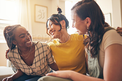 Buy stock photo Happy, hug and women friends gossip, speaking and bond with care, trust and story in their home. Smile, embrace and people with diversity in a living room with support, conversation and social visit