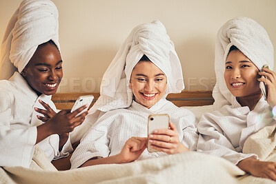 Buy stock photo Spa day, sleepover and friends with phone in bed relax with social media during beauty routine at home. Happy, self care and women in bedroom with smartphone for internet, search or diy skincare idea