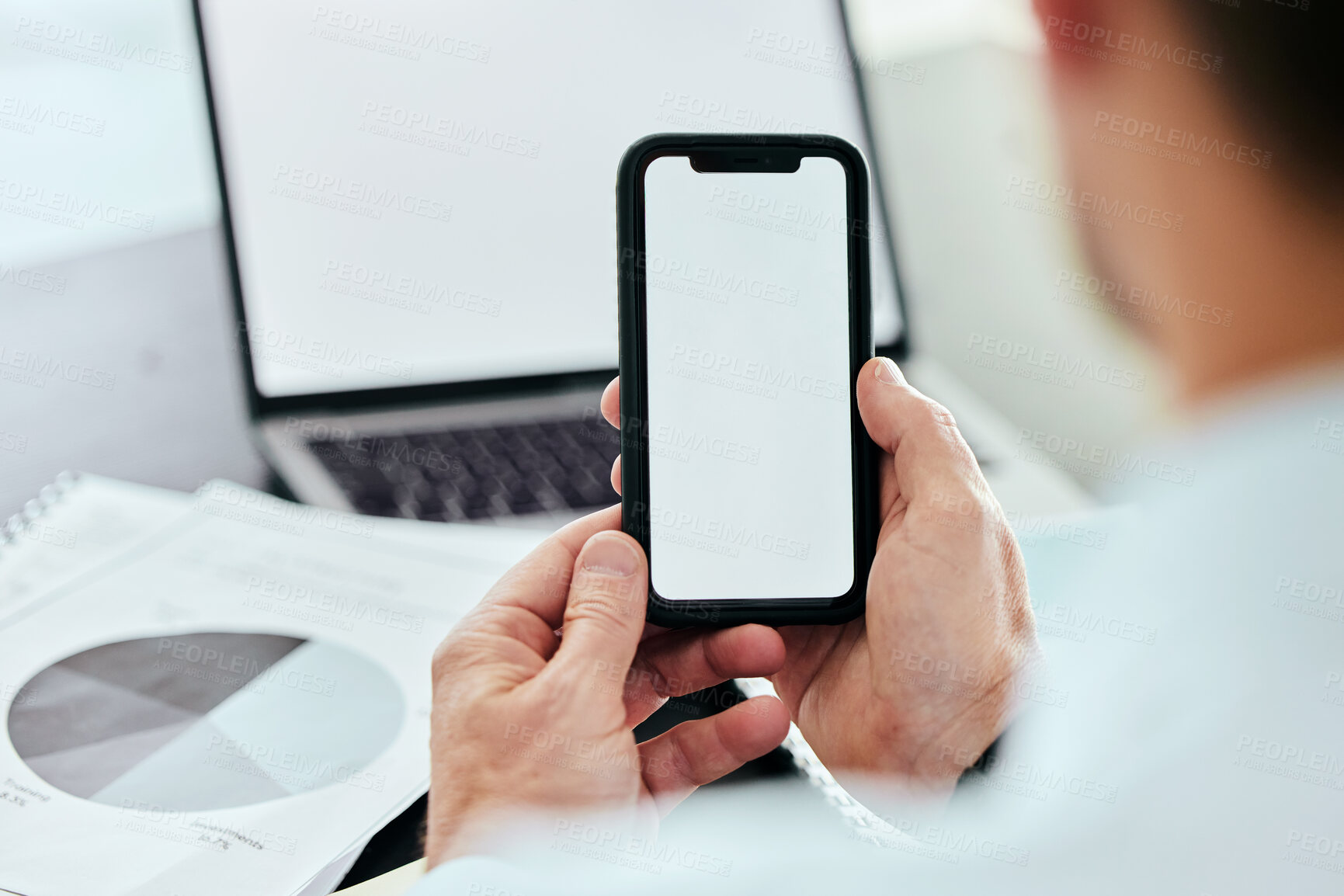 Buy stock photo Mockup space, phone and hands of man with laptop in office for internet, connection and mobile app brand. Advertising, technology and business worker online on smartphone for social media with graph