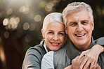 Love, portrait and senior couple hug at a park happy, free and enjoy travel, holiday or weekend. Face, smile and elderly woman embrace man in forest, bond and having fun on retirement trip together