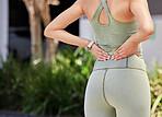 Back, pain and athlete with injury problem due to fitness, workout or outdoor exercise in a nature in the morning. Hurt, muscle strain and rear view of person training with accident on spine