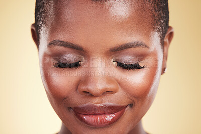 Buy stock photo Makeup, beauty and face of a black woman in studio for self care, skin glow and cosmetics. Closeup of african person or aesthetic model with facial shine and eyelash extension on a beige background