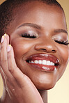 Beauty, makeup and a happy woman with hand on face for self care, skin glow and cosmetics. Closeup of african person or model with facial shine, eyelash extension and a smile on a studio background