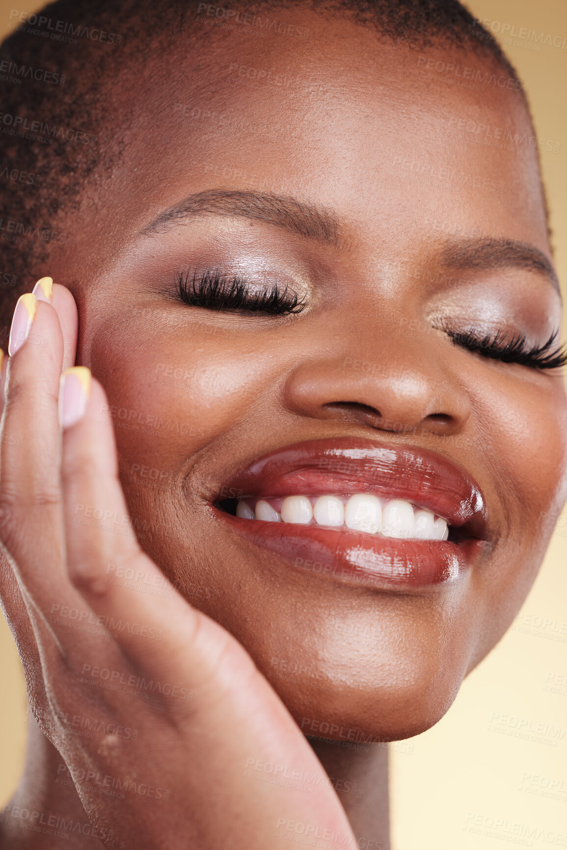 Buy stock photo Beauty, makeup and a happy woman with hand on face for self care, skin glow and cosmetics. Closeup of african person or model with facial shine, eyelash extension and a smile on a studio background