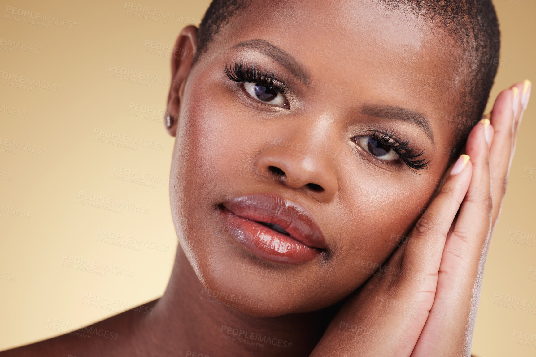Buy stock photo Beauty, natural makeup and face of a black woman in studio with hands on skin care, glow and cosmetics. Portrait of african person or model with facial shine and wellness on a beige background