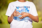 Volunteer hands, plastic bottle and park for community service, recycling and climate change or earth day project. Person volunteering outdoor or nature for eco friendly cleaning or nonprofit support