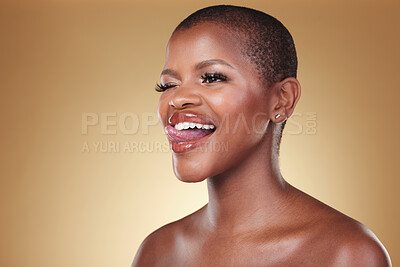 Buy stock photo Makeup, tongue out and black woman wink in studio for cosmetic wellness on brown background space. Beauty, face and African model with crazy emoji expression and glowing skin, results or satisfaction