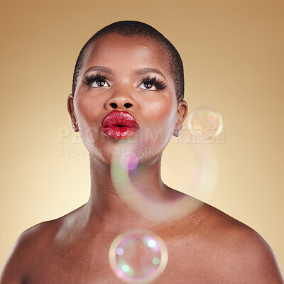 Buy stock photo Luxury, makeup and bubbles with face of black woman in studio for cosmetics, spa treatment and beauty. Skincare, dermatology and self care with model on gold background for glow, facial and soap