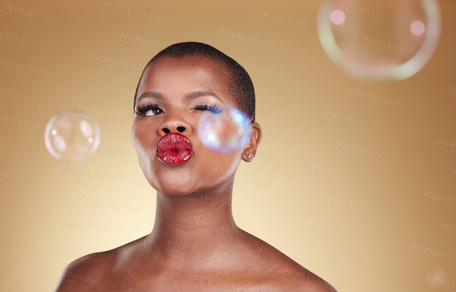 Buy stock photo , makeup and bubbles with face of black woman in studio for cosmetics, spa treatment and luxury. Skincare, dermatology and self care with model on gold background for glow, facial and soap mockup