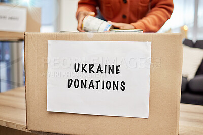 Buy stock photo Box, donation and charity to support Ukraine with empathy, kindness and love for human rights, food or gift. Person, volunteer and hands with product, cardboard package and care for war victims