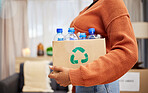 Plastic, recycling and woman with bottle in box in home for eco friendly, reusable and renewable trash. Sustainability, conservation and person with container to reduce waste, litter and garbage