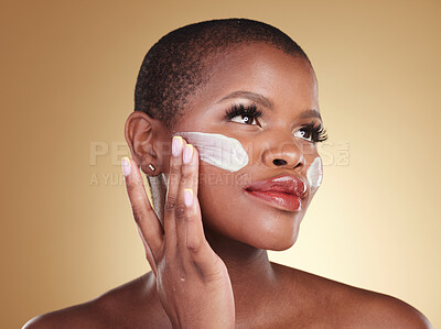 Buy stock photo Application, skincare and face cream for black woman in studio for dermatology or cosmetic wellness on brown background. Beauty, hand and model with facial, sunscreen or collagen, mask or scrub