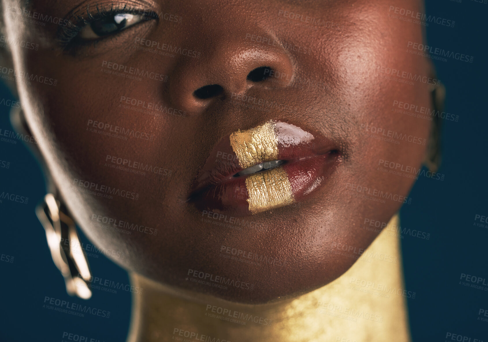 Buy stock photo Portrait, beauty and black woman in gold for culture, heritage or tradition on a blue background in studio. Face, skincare and african style with a young model closeup for elegance or cosmetics