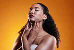 Beauty, makeup and curly hair with face of woman in studio for texture, fashion and cosmetics. Self care, salon and hairstyle with model on orange background for skincare, spa treatment and mockup