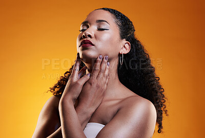 Buy stock photo Beauty, makeup and curly hair with face of woman in studio for texture, fashion and cosmetics. Self care, salon and hairstyle with model on orange background for skincare, spa treatment and mockup