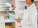 Woman, pharmacist and inventory inspection on pills, tablets or medication on shelf at the pharmacy. Female person, medical or healthcare worker checking stock or pharmaceutical products at drugstore