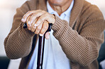 Hands, walking stick and senior person with a disability in nursing home for mobility support, help and balance closeup. Elderly patient, fingers and cane in house living room or arthritis healthcare