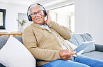 Portrait, home and old man with tablet, headphones and smile with connection, streaming music and radio. Senior person, technology and pensioner with headset, listening to audio and sound on a couch