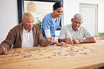 Puzzle game, caregiver and senior men playing for entertainment or bonding together in a retirement home. Happy, fun and elderly people enjoy mental rehabilitation and development with nurse