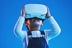 Future, virtual reality or metaverse with girl, glasses or  technology on a blue studio background. Futuristic, kid or child with vr headset, augmented reality or digital transformation with software