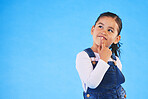 Thinking, child and girl with ideas, decision and choice on a blue studio background. Mockup space, kid and model with doubt, planning and inspiration with problem solving, question and opportunity